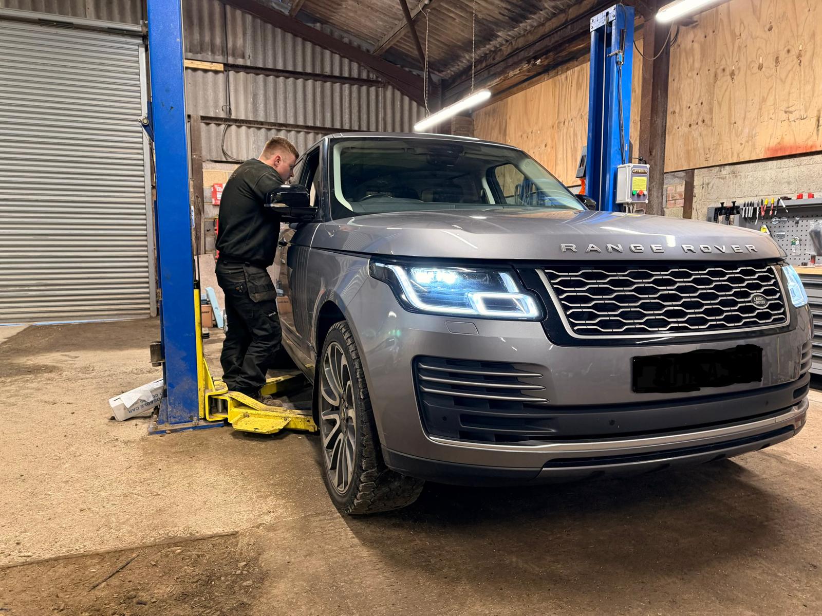 Range Rover on a hydraulic lift inside the Southern VSR workshop