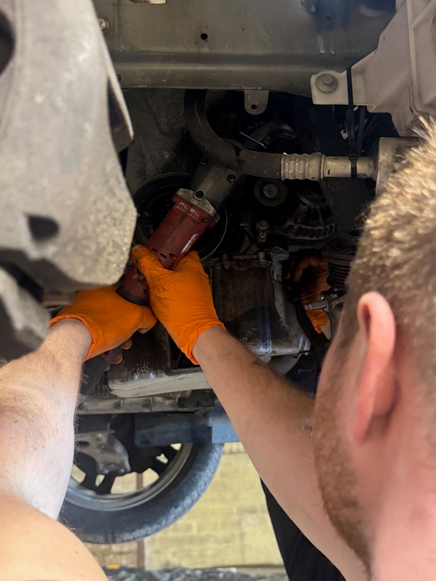 Technician removing an underside fastener with a cordless impact gun at Southern VSR
